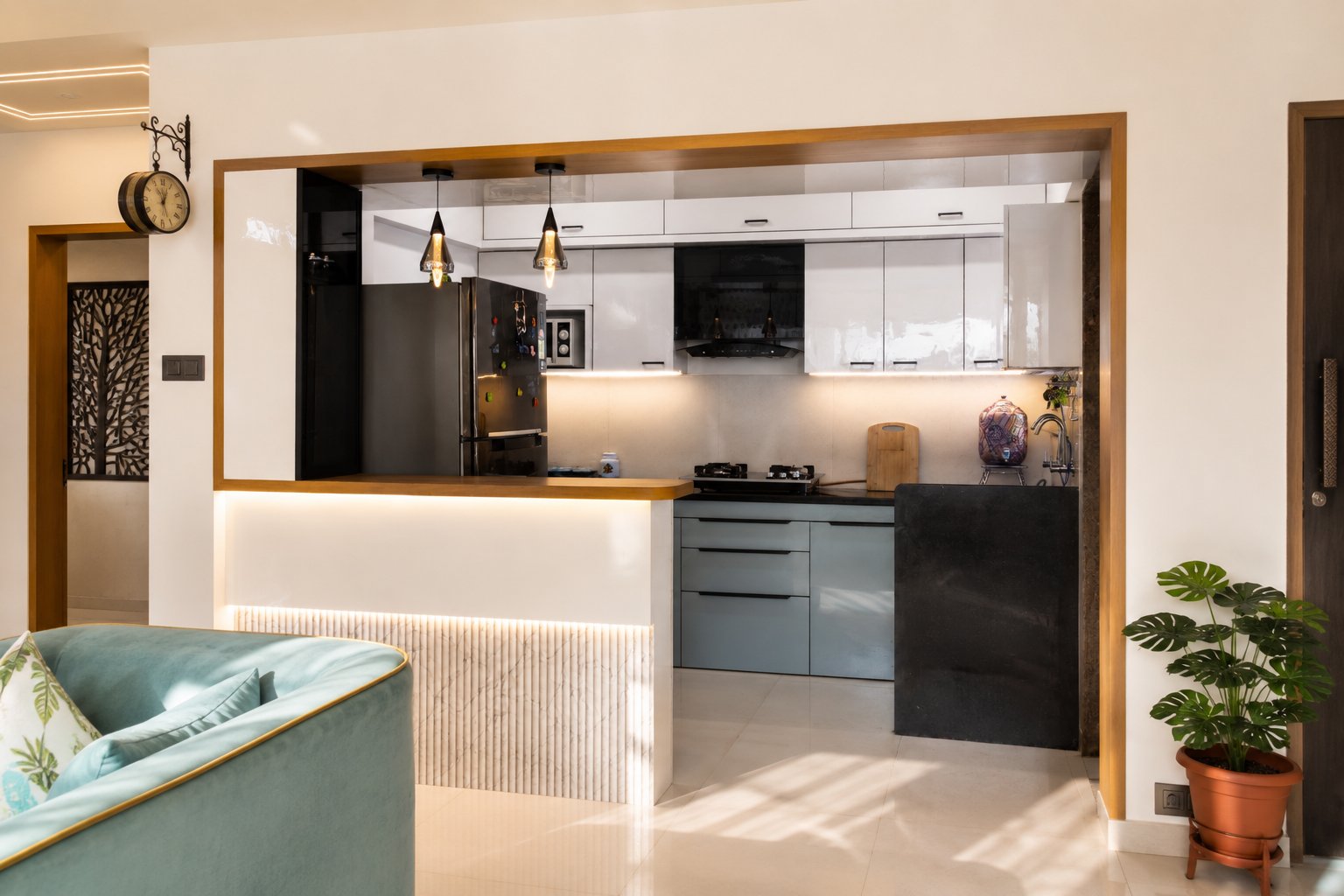 Open kitchen seen from the living room seating — 2 BHK, Balewadi, by Twin Space Studio